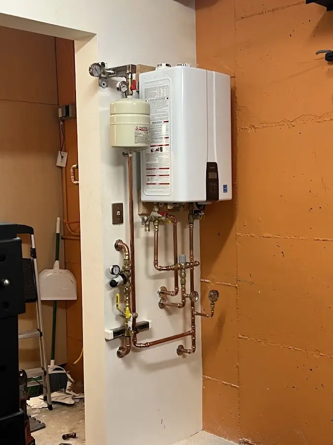 Plumbing technician inspecting water heater connections in Brooksville